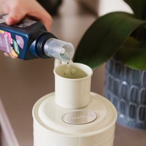 Westland Orchid Feed filled with liquid poured into watering can