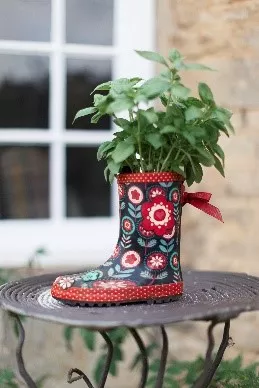 flowers planted in wellington boots display