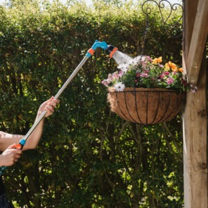 flopro telescopic watering lance in use watering hanging basket