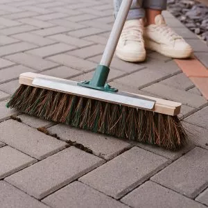mixed broom with scraper in use