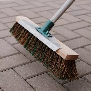 mixed broom with scraper in use