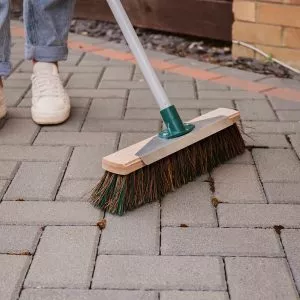 mixed broom with scraper in use