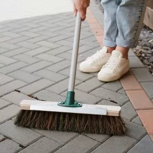 mixed broom with scraper in use