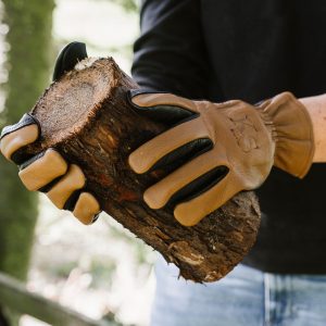 kent and stowe sure and soft leather gloves holding log